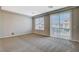Bedroom featuring plush carpet, natural light from large windows, and access to a private balcony at 5309 Tartan Hill Ave, Las Vegas, NV 89141