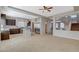 Open-concept living room and kitchen feature tile flooring and stainless appliances at 5309 Tartan Hill Ave, Las Vegas, NV 89141