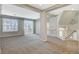 Inviting living area with plush carpet, neutral tones, sliding glass door access to an outdoor patio, and staircase at 5309 Tartan Hill Ave, Las Vegas, NV 89141