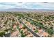 Expansive aerial view of a residential neighborhood with mountain views and terracotta tile roofs at 5609 Indian Ridge Dr, North Las Vegas, NV 89031