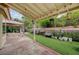 The backyard features a covered patio, outdoor lighting, and well-maintained landscaping at 5609 Indian Ridge Dr, North Las Vegas, NV 89031
