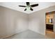 The carpeted bedroom offers a ceiling fan and is adjacent to the bathroom at 5609 Indian Ridge Dr, North Las Vegas, NV 89031