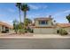 Charming two-story home with a tile roof, mature landscaping, and an attached two-car garage at 5609 Indian Ridge Dr, North Las Vegas, NV 89031