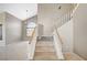 Inviting 2-story foyer featuring a staircase, elegant lighting, and neutral wall colors and views to living spaces at 5609 Indian Ridge Dr, North Las Vegas, NV 89031