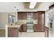 Bright kitchen featuring stainless steel appliances, granite countertops, and wooden cabinetry at 5609 Indian Ridge Dr, North Las Vegas, NV 89031