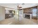 Open-concept living room featuring a fireplace, tile flooring, and a breakfast bar to the kitchen at 5609 Indian Ridge Dr, North Las Vegas, NV 89031