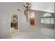 Spacious living room featuring tile flooring, a staircase, and large windows, with kitchen access at 5609 Indian Ridge Dr, North Las Vegas, NV 89031