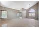 Bright living room featuring tile flooring, tall vaulted ceilings, and ample natural light from large windows at 5609 Indian Ridge Dr, North Las Vegas, NV 89031