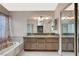 Beautifully decorated main bathroom suite offers a soaking tub, walk-in shower, and dual vanity with ample storage at 5609 Indian Ridge Dr, North Las Vegas, NV 89031