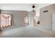 Spacious main bedroom with a decorative light fixture, natural light and an attached bathroom suite with separate tub at 5609 Indian Ridge Dr, North Las Vegas, NV 89031