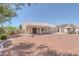 Inviting backyard features desert landscaping, mature trees and a covered patio at 5808 Spinnaker Reach Ave, Las Vegas, NV 89130