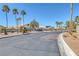 Well-maintained street view of a residential area, showcasing mature palm trees and tidy landscaping at 5808 Spinnaker Reach Ave, Las Vegas, NV 89130