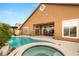 Inviting backyard with a refreshing pool, spa, and comfortable seating area, perfect for outdoor enjoyment at 5940 Vizzi Ct, Las Vegas, NV 89131