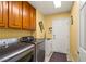 Laundry area showcases modern Samsung washer and dryer set, cabinet space, and a convenient utility sink at 5940 Vizzi Ct, Las Vegas, NV 89131