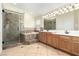 Bathroom featuring double sink vanity, separate shower and soaking tub at 6779 Rainstorm Ridge Ave, Las Vegas, NV 89131