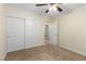 This bedroom features a ceiling fan, carpet flooring, a closet, and cream colored walls at 6779 Rainstorm Ridge Ave, Las Vegas, NV 89131