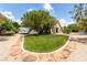 Grassy front yard with mature shade tree, RV parking, and rock landscaping leading to front entrance at 6779 Rainstorm Ridge Ave, Las Vegas, NV 89131