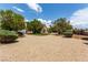 The front of a large single-Gathering home with mature landscaping, rock lawn, and RV parking at 6779 Rainstorm Ridge Ave, Las Vegas, NV 89131