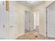 Hallway with tiled flooring, white trim, and multiple doorways at 6779 Rainstorm Ridge Ave, Las Vegas, NV 89131