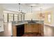 Kitchen with breakfast bar, granite countertops, wooden cabinets, and black appliances at 6779 Rainstorm Ridge Ave, Las Vegas, NV 89131