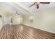 Spacious living room featuring wood flooring, and multiple ceiling fans at 6779 Rainstorm Ridge Ave, Las Vegas, NV 89131