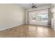 Bright living room featuring tile flooring, neutral walls, and three large windows with decorative blinds at 6779 Rainstorm Ridge Ave, Las Vegas, NV 89131