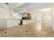 Spacious open-concept living room and kitchen with tile floors and modern lighting at 6779 Rainstorm Ridge Ave, Las Vegas, NV 89131