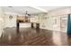 Expansive living space with hardwood floors, fireplace, kitchen view, and sliding glass doors at 6779 Rainstorm Ridge Ave, Las Vegas, NV 89131