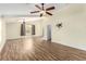 Open living space with wood-look flooring and dual ceiling fans at 6779 Rainstorm Ridge Ave, Las Vegas, NV 89131