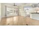 Open floor plan showing the living room and kitchen area with tile flooring and neutral paint at 6779 Rainstorm Ridge Ave, Las Vegas, NV 89131