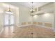 Spacious living room featuring neutral paint, tile flooring, decorative trim, and French doors to entry at 6779 Rainstorm Ridge Ave, Las Vegas, NV 89131