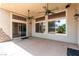 This covered patio features ceiling fans, and lots of natural light from the sliding glass doors and windows at 6779 Rainstorm Ridge Ave, Las Vegas, NV 89131