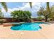 A clear view of a well-kept swimming pool with attached spa, rock features, and tidy landscaping at 6779 Rainstorm Ridge Ave, Las Vegas, NV 89131