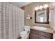 Bathroom features a shower with a curtain, toilet, and vanity with storage at 6800 E Lake Mead Blvd # 2089, Las Vegas, NV 89156