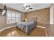 Comfortable bedroom featuring natural light, ceiling fan, and stone-accented wall at 6800 E Lake Mead Blvd # 2089, Las Vegas, NV 89156