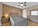 Comfortable bedroom featuring natural light, ceiling fan, and stone-accented wall at 6800 E Lake Mead Blvd # 2089, Las Vegas, NV 89156