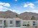 Exterior view of condos, set against a backdrop of striking mountain range under a blue sky at 6800 E Lake Mead Blvd # 2089, Las Vegas, NV 89156