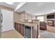 Open kitchen with modern appliances, granite countertops, wine fridge, and view to the living room at 6800 E Lake Mead Blvd # 2089, Las Vegas, NV 89156