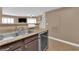 Modern kitchen with granite countertops, stainless steel sink, and view into the living room at 6800 E Lake Mead Blvd # 2089, Las Vegas, NV 89156