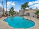 Community pool area with sun loungers, lush landscaping, and inviting blue water at 6800 E Lake Mead Blvd # 2089, Las Vegas, NV 89156