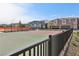Outdoor basketball court with black metal fencing, perfect for community fun, with houses in the background at 6807 Satin Silver Ct, North Las Vegas, NV 89086