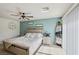 Relaxing bedroom features a fan, sliding glass door, and soothing turquoise accent wall at 6807 Satin Silver Ct, North Las Vegas, NV 89086