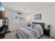 Cozy bedroom featuring a comfortable bed with a striped cover and a wall-mounted TV at 6807 Satin Silver Ct, North Las Vegas, NV 89086