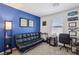 Comfortable bedroom space with futon, desk, and bright blue accent wall at 6807 Satin Silver Ct, North Las Vegas, NV 89086