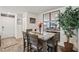 Cozy dining area with a modern table set, decorative mirrors, and natural lighting, perfect for Gathering meals at 6807 Satin Silver Ct, North Las Vegas, NV 89086