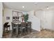 Cozy dining area with a modern table set, decorative mirrors, and natural lighting, perfect for Gathering meals at 6807 Satin Silver Ct, North Las Vegas, NV 89086