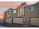 View of townhome garages with neutral paint, offering ample parking and storage space in a well-maintained community at 6807 Satin Silver Ct, North Las Vegas, NV 89086