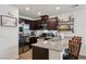 Well-lit kitchen with stainless steel appliances, barstool seating, and granite countertops at 6807 Satin Silver Ct, North Las Vegas, NV 89086