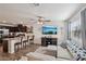 Open-concept living space flows into kitchen, with stainless steel appliances, island seating, and modern furnishings at 6807 Satin Silver Ct, North Las Vegas, NV 89086