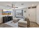 Bright living room features a comfortable sectional sofa, modern decor, and a TV, creating an inviting space at 6807 Satin Silver Ct, North Las Vegas, NV 89086